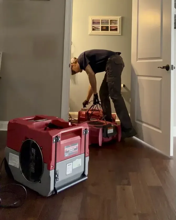 Red drying machines being adjusted at an interior doorway