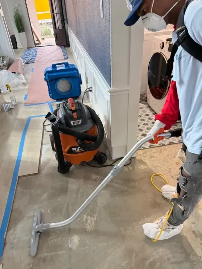 Standing water being extracted from a flooded floor in a home